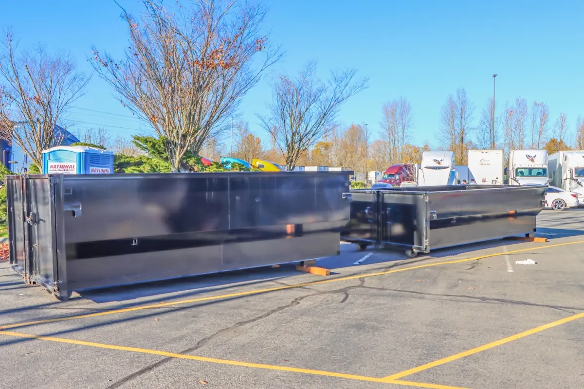 Professional dumpster rental service with roll-off container on residential driveway in Morganton